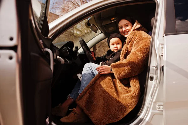 Young mother and child in car. Safety driving concept.