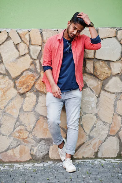 Portrait of young stylish indian man model pose in street.