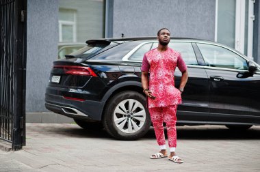 Siyah bir gencin portresi, Afrikalı geleneksel kırmızı renkli kıyafetler giyiyor..