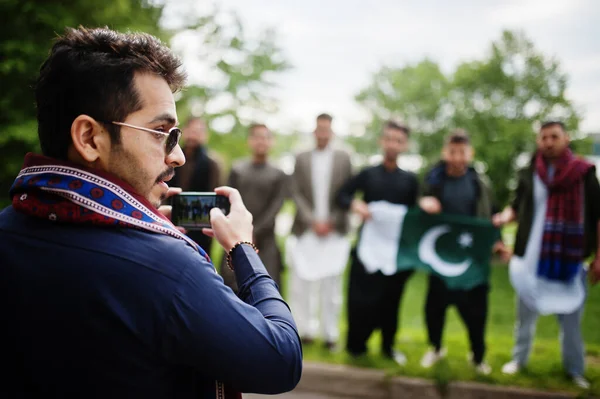 Group of pakistani man wearing traditional clothes salwar kameez or kurta with Pakistan flags.