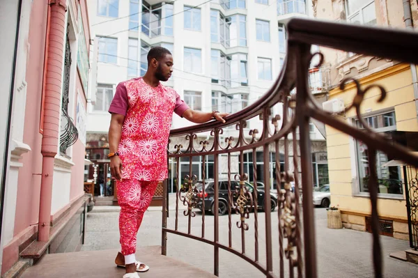 Siyah bir gencin portresi, Afrikalı geleneksel kırmızı renkli kıyafetler giyiyor..