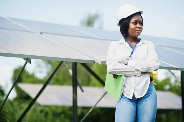 African american technician check the maintenance of the solar panels. Black woman engineer at solar station.