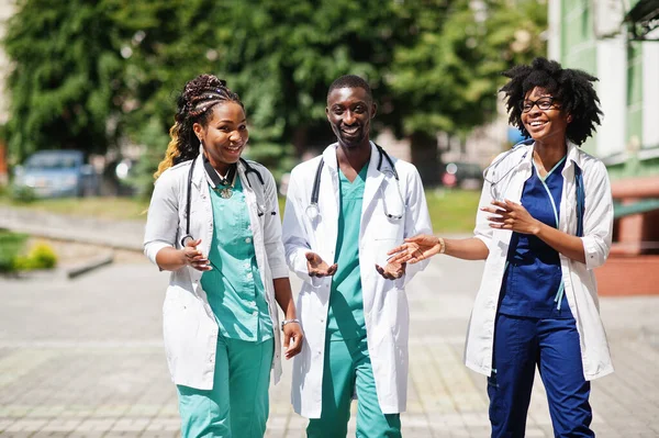 Three African American group doctors with stethoscope wearing lab coat.