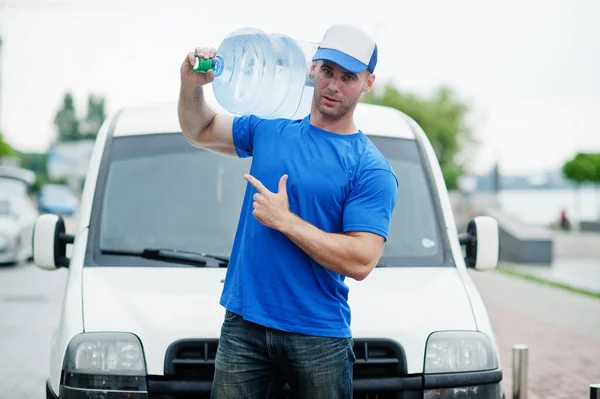 Delivery man in front cargo van delivering bottles of water showing finger.