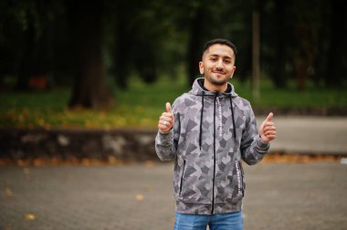 Student kuwaiti man wear at hoodie show thumbs up. clipart