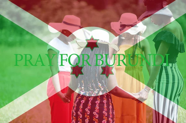 Pray for Burundi. Group of four african women holding hands and praying. Concept of crisis in Africa country.