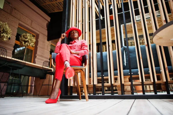 Pretty braids business african american lady bright bossy person friendly wear office red shirt, hat and trousers. 