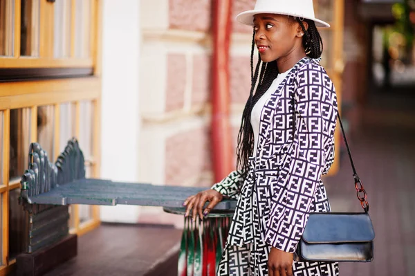 Beautiful african american woman natural makeup wear fashion clothes casual black and white dress code office style total blouse and pants suit and hat.