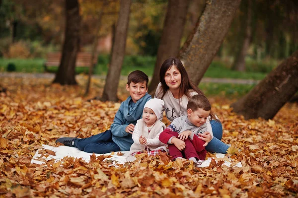 秋の紅葉公園で幸せな家族 3人の子供を持つ母親 — ストック写真