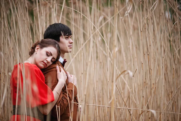 Young beautiful couple in the bulrush — Stock Photo, Image
