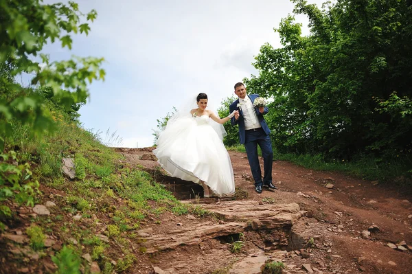 Beautiful wedding couple on a red rock — Stock Photo, Image