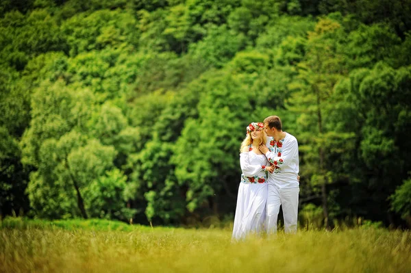 Young  beautiful couple in traditional dress walking — Stock Photo, Image