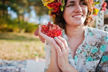 happy girl with a wreath on his head at the autumn forest