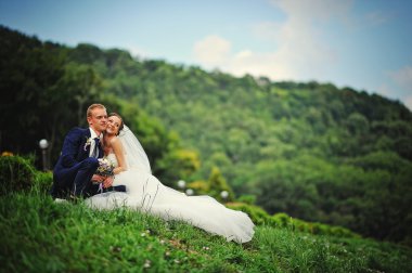 young happy wedding couple at the nice nature 