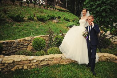 young happy wedding couple at the nice nature 