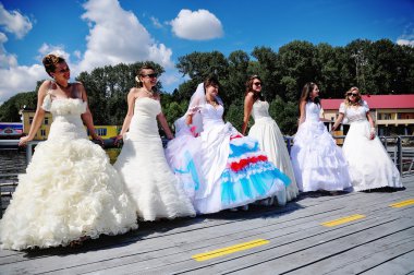 brides having fun on the beach