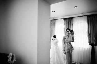 Young brunette bride looked at the mirror