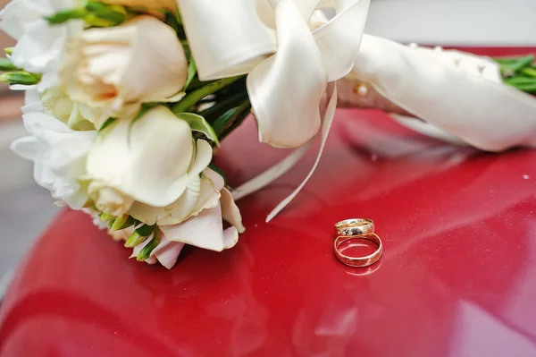 Düğün buketi yüzük kırmızı zemin üzerine — Stok fotoğraf
