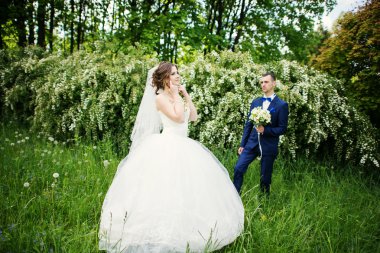 Genç güzel ve parkta yürüyüş çarklı Düğün çifti