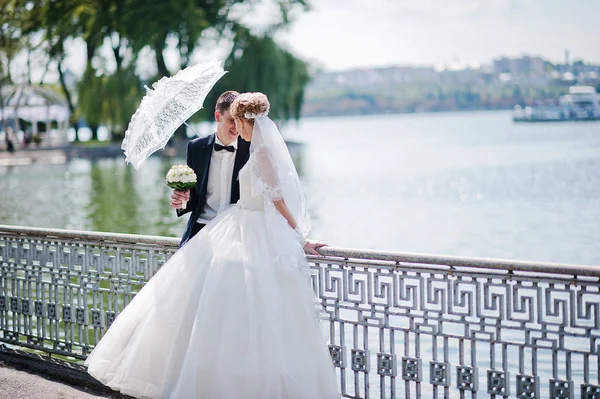 Vzrušující elegantní Svatební pár procházky v parku v lásce s umb — Stock fotografie