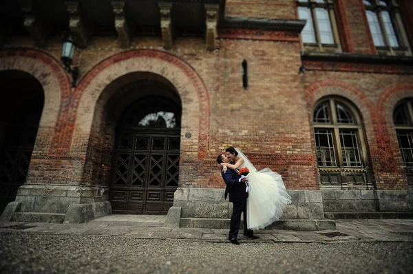 Newlyweds background  old brick architecture house and tower — Stock Photo, Image