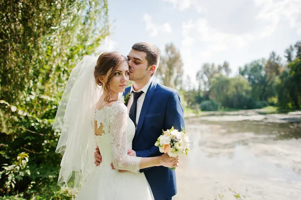 Ślub pary w parku w pobliżu dwa kamienie i jeziora — Zdjęcie stockowe