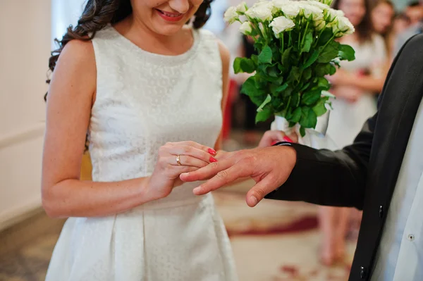 Mariée porte une bague de mariage sur la main du marié — Photo