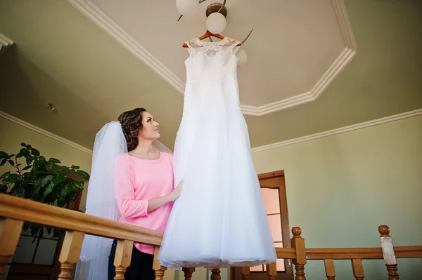 Bela jovem noiva olhando no vestido de noiva — Fotografia de Stock