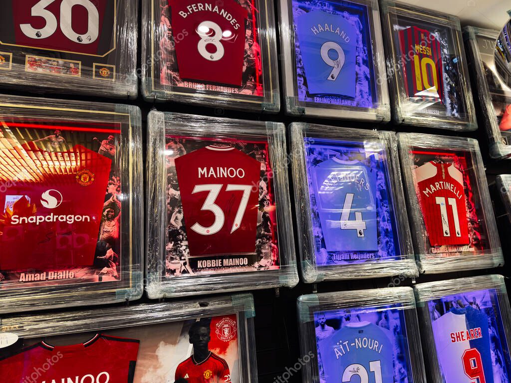 Manchester, UK - September 26, 2025: Colorful display of framed team jerseys with numbers and names, creating a sports memorabilia scene.