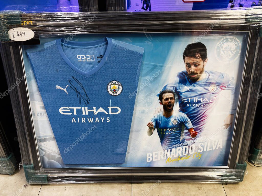 Manchester, UK - September 26, 2025: Autographed Bernardo Silva blue jersey poster framed for decor, featuring Etihad Airways branding and Manchester City imagery.