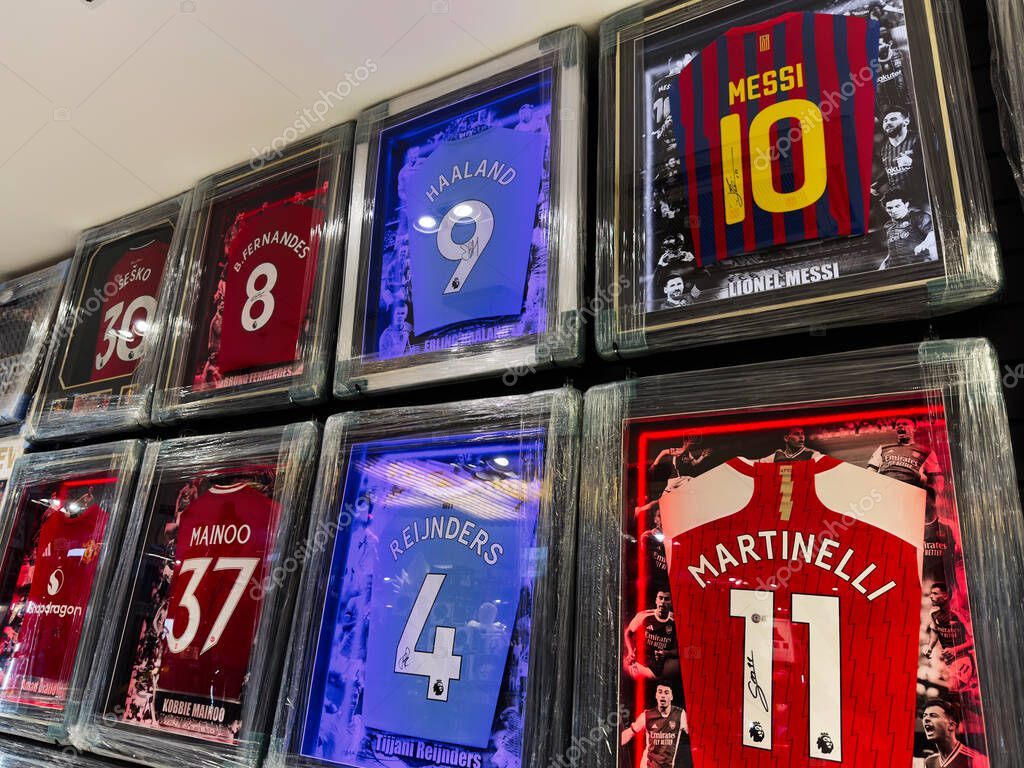 Manchester, UK - September 26, 2025: A wall-mounted display of framed soccer jerseys featuring famous players from top clubs.