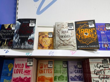 Manchester, İngiltere - 26 Eylül 2025: Leigh Bardugo, Karga Altı, Yara Kralı, Kurtların Yönetimi ve Iron Flame kitapçıda sergilenen rafta.