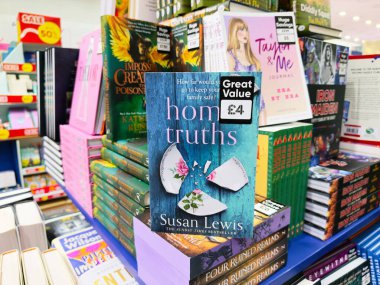 Manchester, İngiltere - 26 Eylül 2025: Susan Lewis 'in Ev Gerçekleri adlı kitabı diğer popüler romanlarla birlikte raflarda yer aldı.