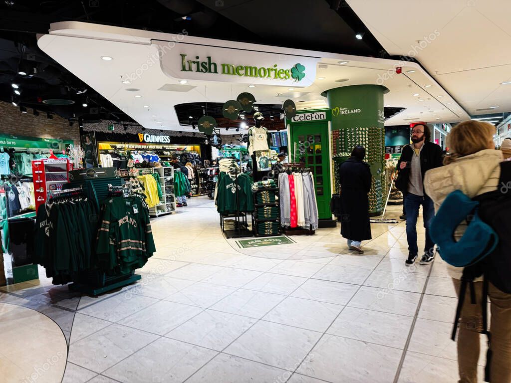 Dublin, Ireland - October 24, 2025: Inside a Dublin store, visitors browse green Ireland apparel and souvenirs amid Irish memories.