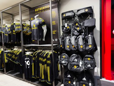 Manchester, İngiltere - 30 Eylül 2025: Manchester mağazasında siyah sarı formalar ve çantalar sergilenmektedir..