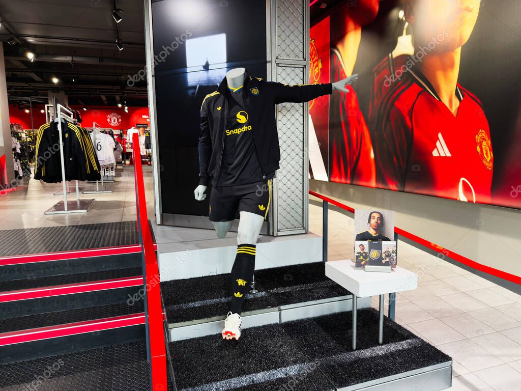 Manchester, UK - September 30, 2025: Mannequin in a Manchester United kit on display in a Manchester sports shop with bold red branding.