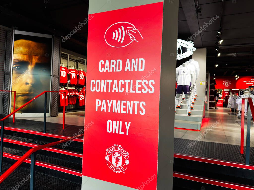Manchester, UK - September 30, 2025: Bright red sign promotes card and contactless payments inside a Manchester retail store.