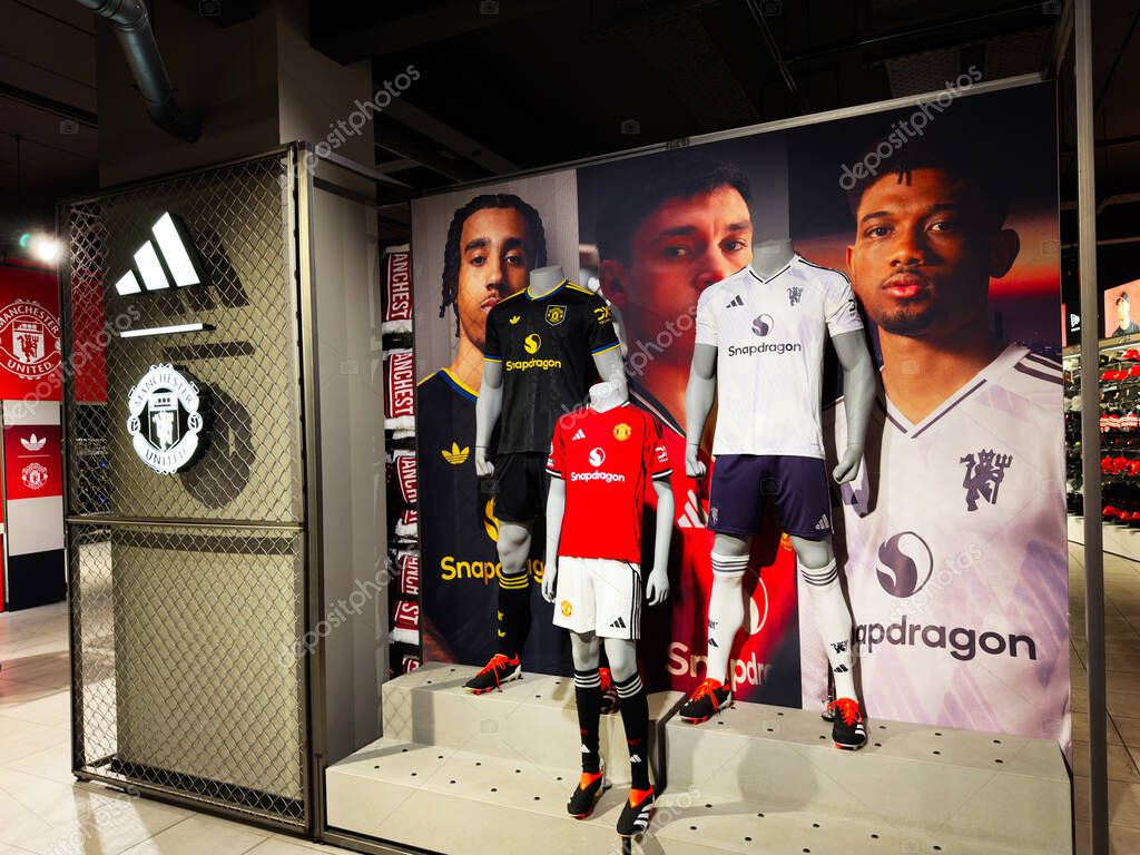 Manchester, UK - September 30, 2025: Football kits and mannequins featured in a Manchester UK store display showing branding and sports apparel.
