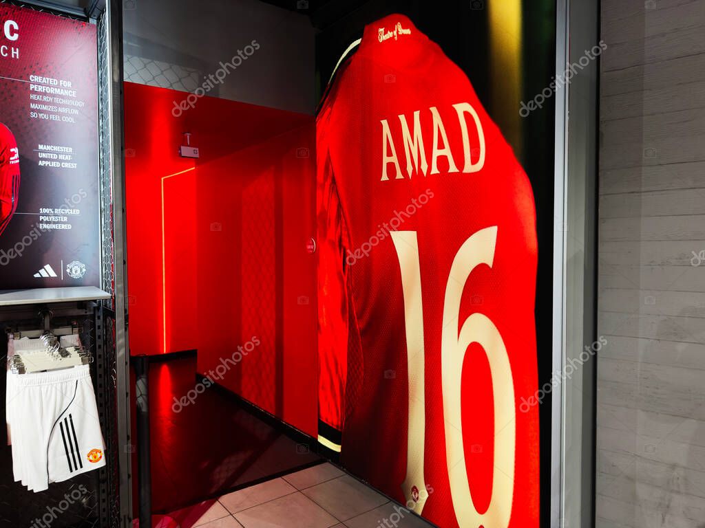 Manchester, UK - September 30, 2025: Red Manchester United jersey with Amad 16 on display in a store in Manchester, UK.