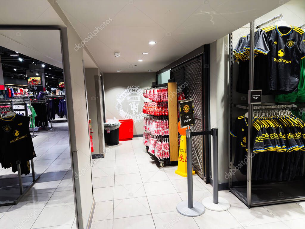 Manchester, UK - September 30, 2025: Bright Manchester store interior with United jerseys and merchandise on racks and shelves in Manchester UK.
