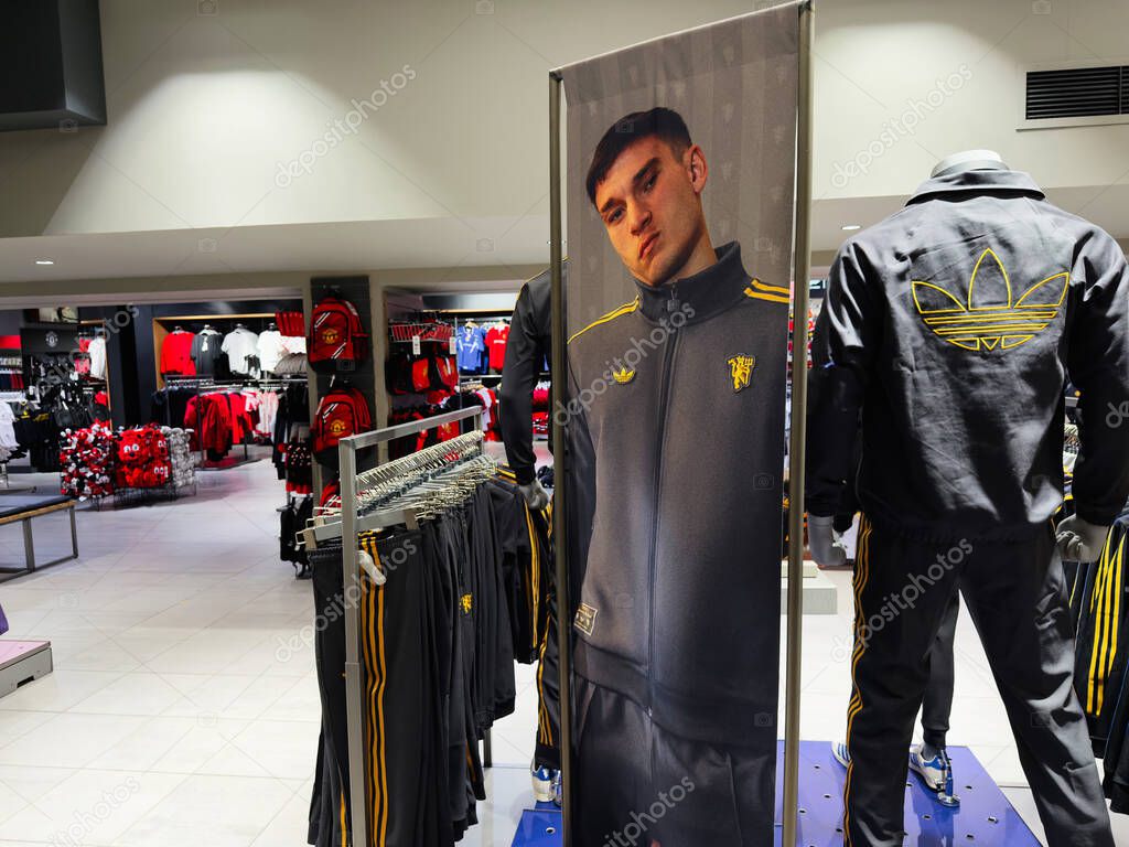 Manchester, UK - September 30, 2025: Sportswear display in Manchester shop features Adidas tracksuits and jackets on mannequins, bright lighting, modern retail atmosphere.