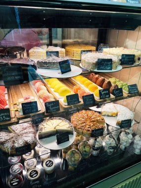 Kyiv, Ukrayna - 10 Kasım 2025: Pastanenin vitrininde geniş bir pasta, makarna ve hamur işi çeşitliliği sergilendi.