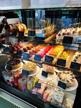 Kyiv, Ukrayna - 10 Kasım 2025: İyi aydınlatılmış bir kafe vitrininde çeşitli tatlı ve hamur işleri oturmaktadır.