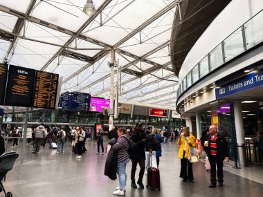 Manchester, İngiltere - Ekim 04, 2025: Kalabalık Manchester UK Piccadilly istasyon merkezi yolcu ve bagaj kalkış panoları ve bilet alanı yakınında.