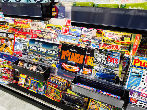 Manchester, UK - December 13, 2025: Vibrant display of automotive magazines on a busy Manchester UK shelf.