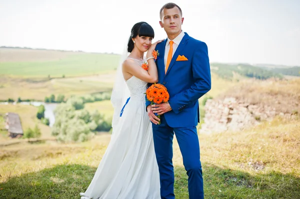 Жених держит невесту за руку на холме — стоковое фото