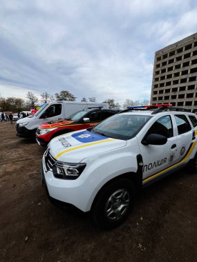 Ternopil, Ukrayna - 29 Kasım 2025: Arka planda kalabalık olan bir inşaat sahasının yakınına park edilmiş polis ve acil durum araçları kuyruğu.