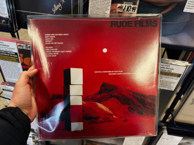 Manchester, İngiltere - 21 Ocak 2026: Rude Films ve albüm sanatı etiketli kayalık çöl manzarasına karşı minimalist beyaz bloklarla kalın kırmızı vinil kapak.