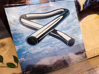 Lviv, Ukrayna - 7 Şubat 2026: Mavi gökyüzüne karşı soyut boru halkalarının yer aldığı Mike Oldfield 'ın albüm kapağı. Tubular Bells 1973