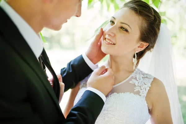 Close up portrait of groom holding hand on face bride — Stock Photo, Image